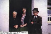 Three People At Doorway Of House In Ballynagoul, ( Baile Na nGall) Ring